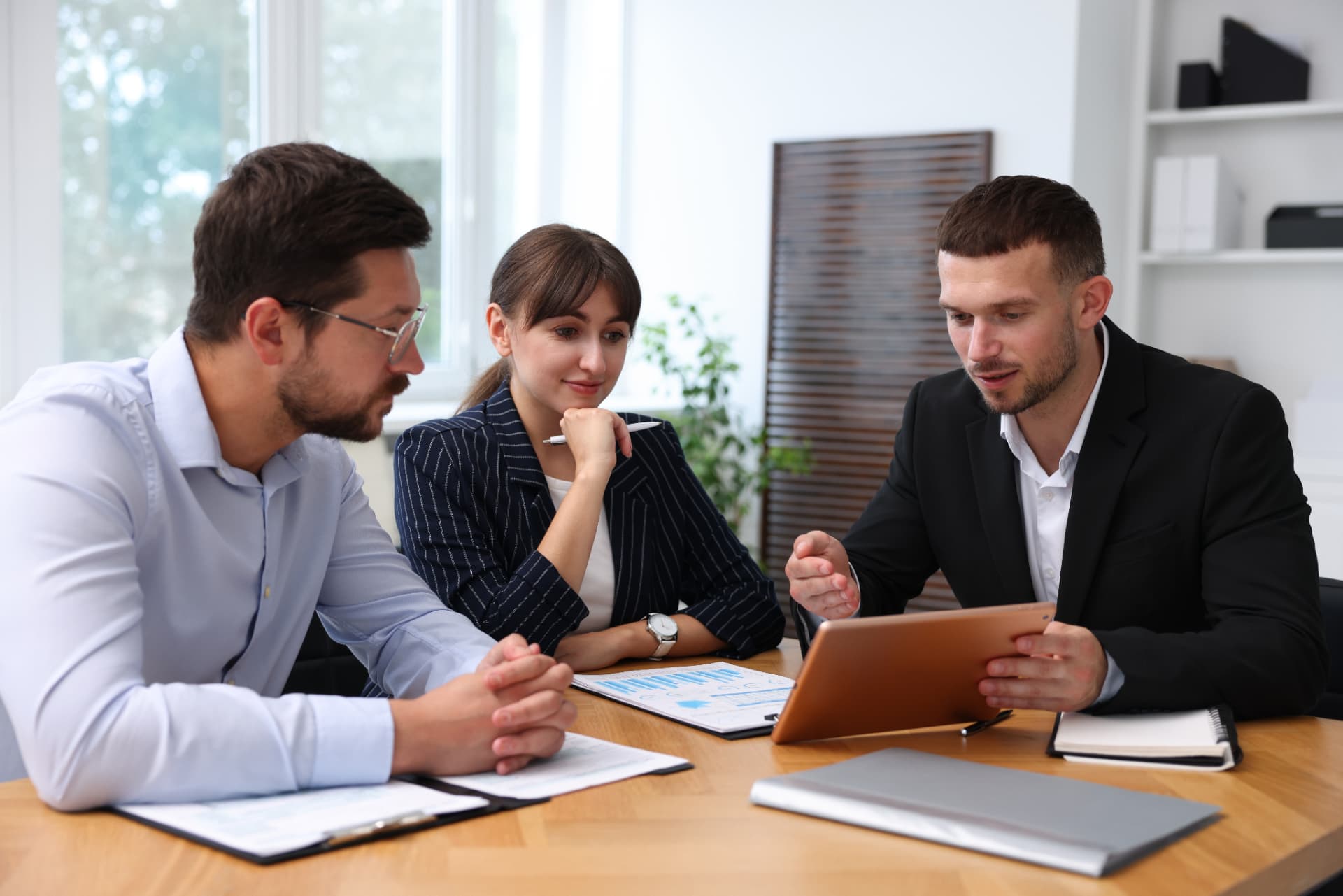 Two business professionals in discussion across a meeting table
